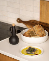 handmade, artisan made, olive oil bottle, olive oil, containers, olive oil dispenser, vinegar dispenser, matte black, matte finish, serveware, drinkware, bouteille d'huile d'olive, bouteille, contenant pour huile et syrop d'érable, noir mat, artisan made, fait à la main, arisanal,  intemporel, design, Dadasi, gharyan stoneware, ethically made, ethique, fair trade, commerce équitable